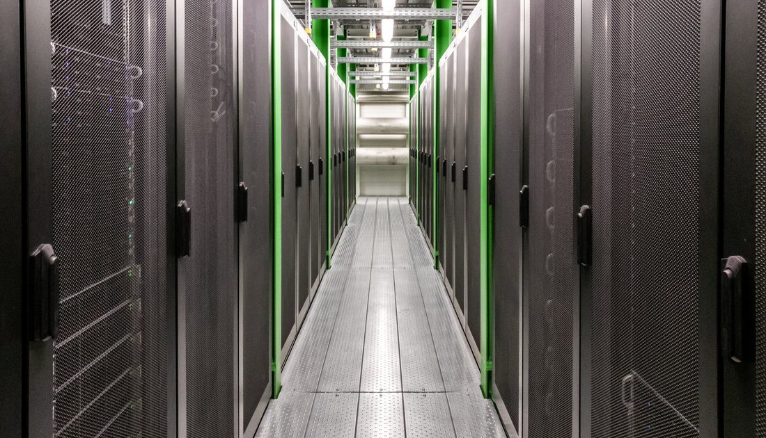 Server racks lined down a cloud data center corridor