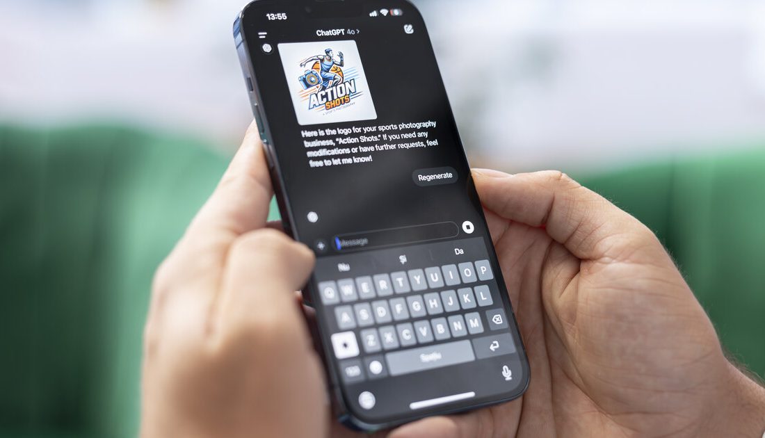 Hand holding a smartphone with the ChatGPT AI assistant app open in a conversation