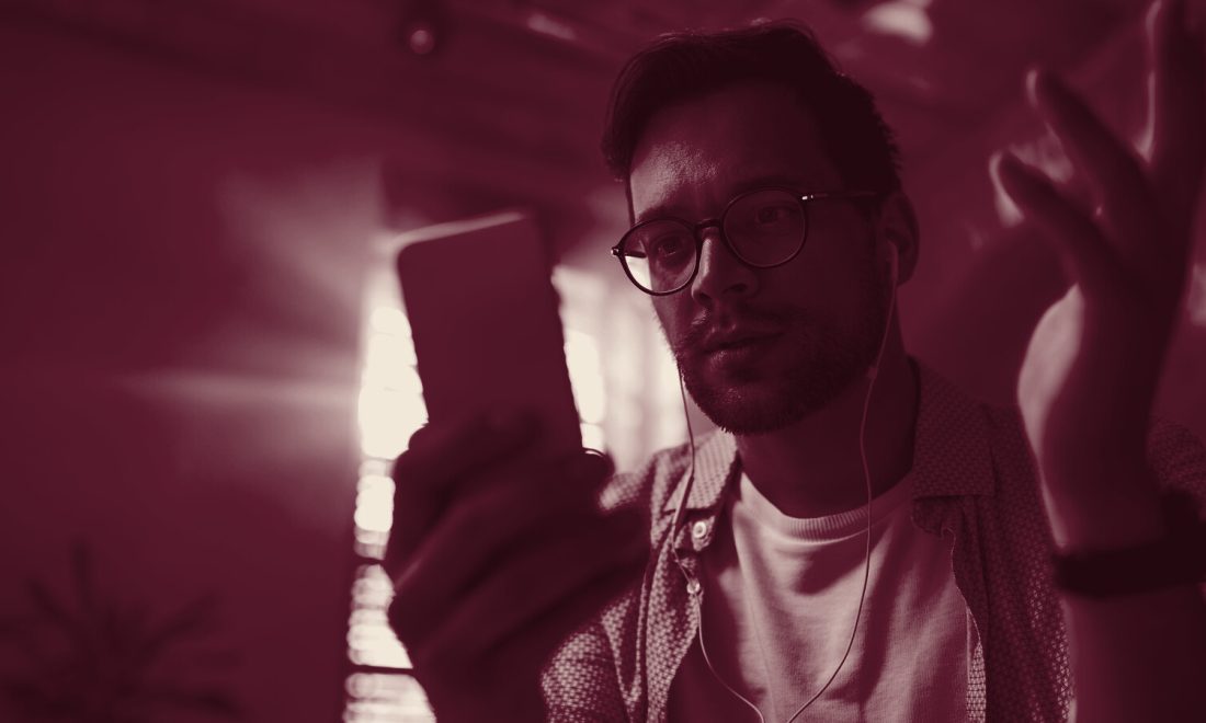 A person regards a phone with uncertainty, reflecting declining trust in AI search