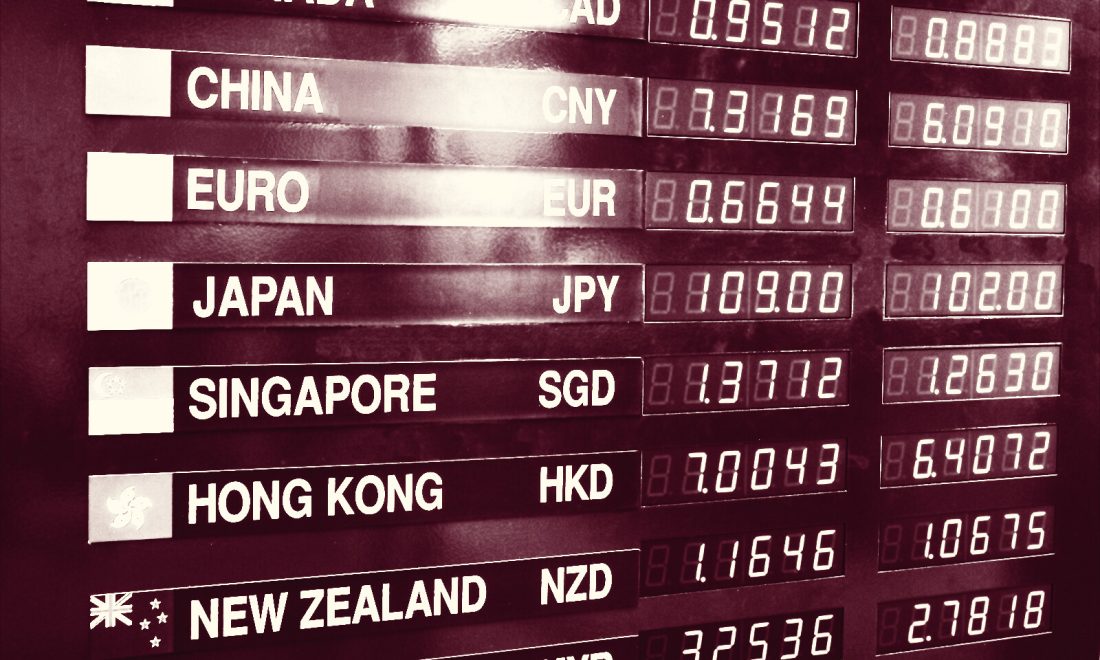 Exchange rate board listing currencies beside LED rate readouts, each value derived from another by a rate