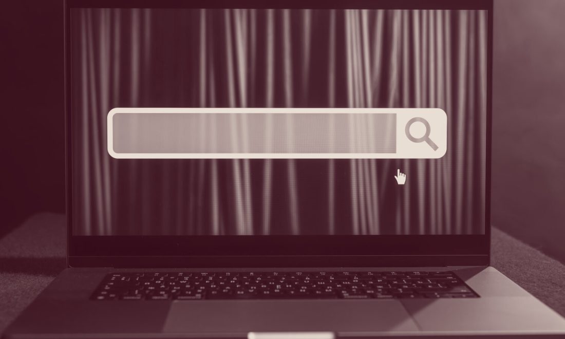 Laptop screen showing an empty input field, wine-toned
