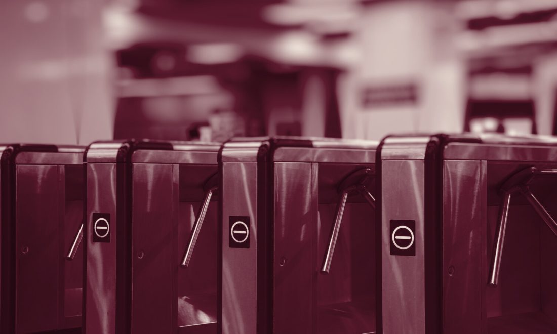 Row of closed tripod turnstiles, each passage gated one at a time