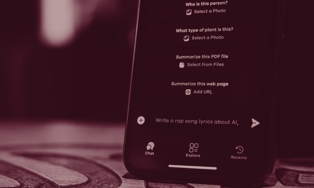 AI assistant chat app open on a smartphone showing suggested prompts, wine duotone